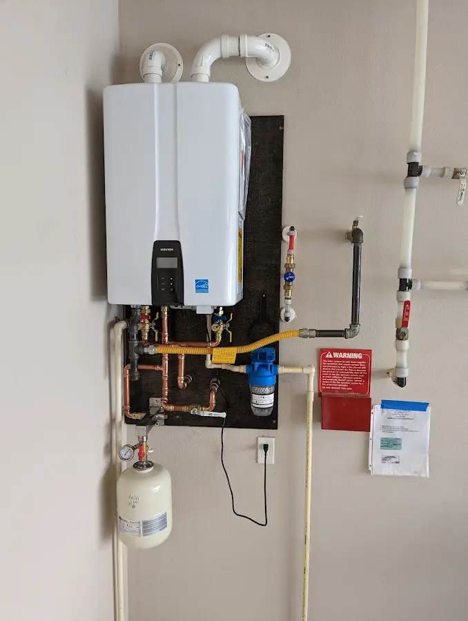 Professional plumber installing copper piping in a Springfield home